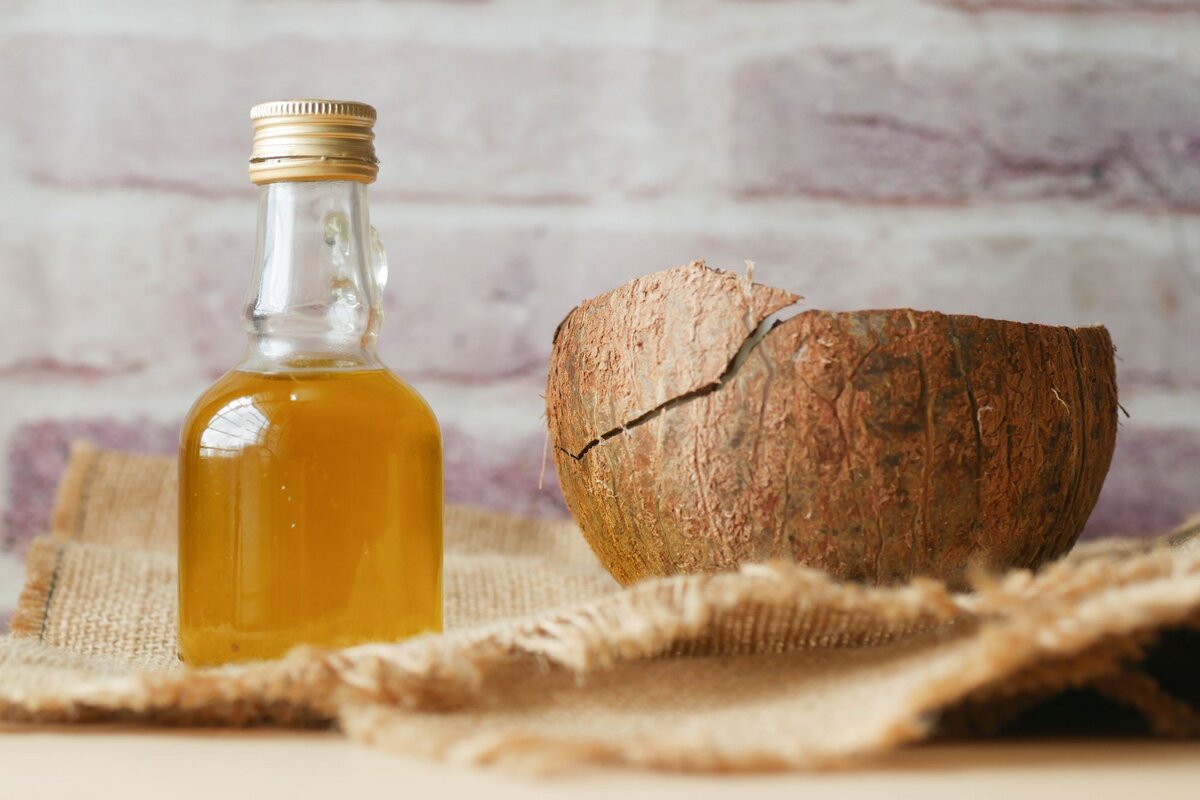 Coconut oil beside a cracked coconut