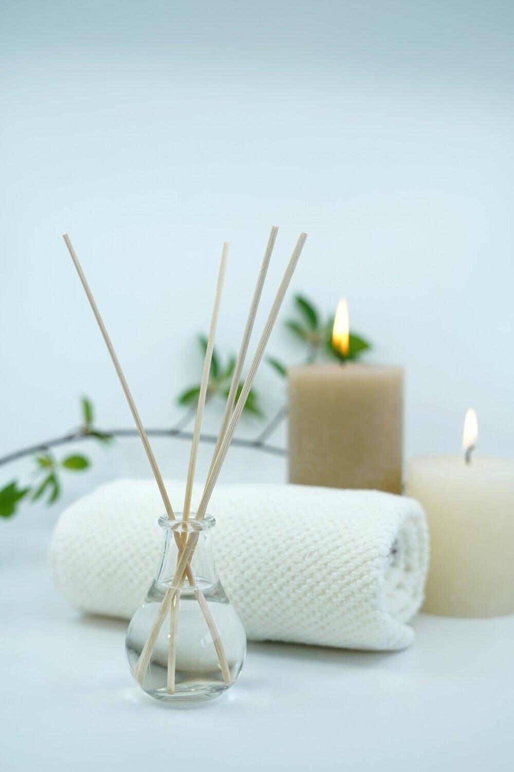 Candles, reeds and rolled towels