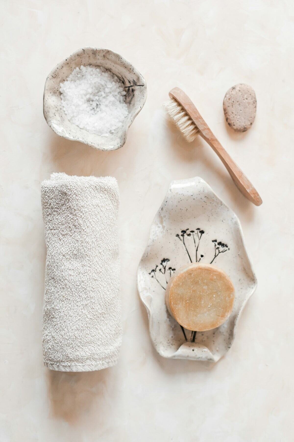 Salt, a brush and a rolled towel